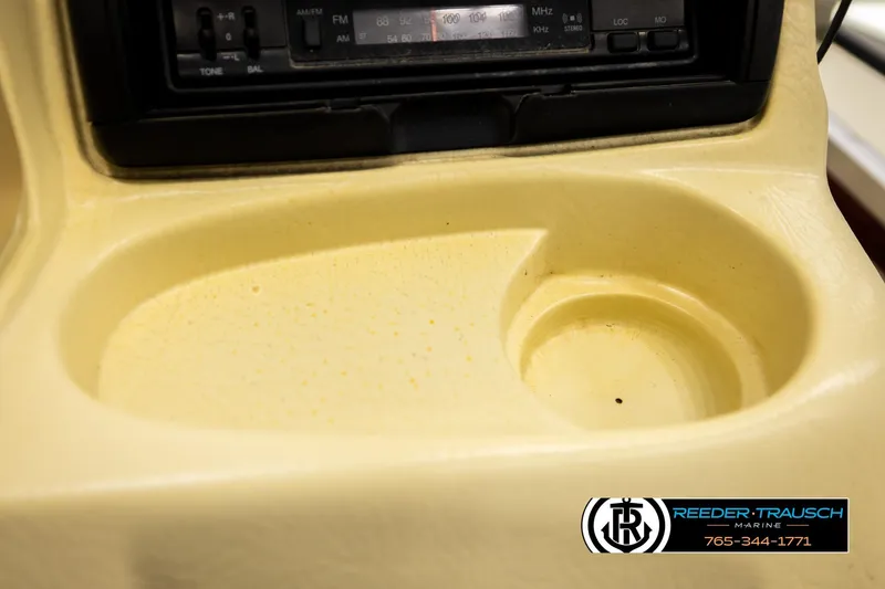 Slide: The Image of 1999 Lowe Sea Nymph V 179 SCX boat console with radio and cup holder. - 32