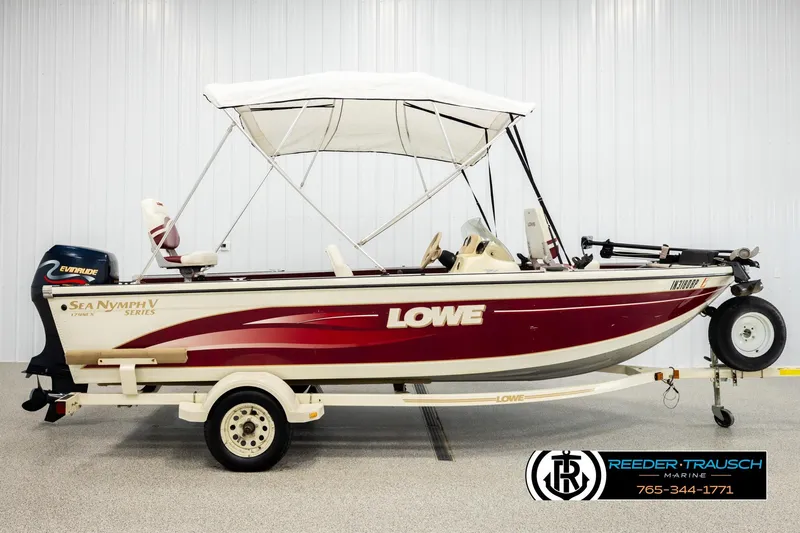 Slide: The Image of 1999 Lowe Sea Nymph V 179 SCX boat with canopy and trailer in showroom. - 4