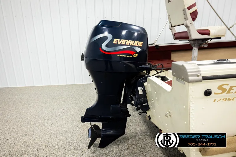 Slide: The Image of 1999 Lowe Sea Nymph V 179 SCX boat with Evinrude outboard motor in showroom. - 44