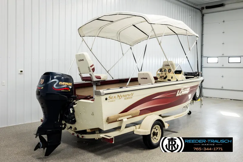 Slide: The Image of 1999 Lowe Sea Nymph V 179 SCX boat with Evinrude motor in a garage setting. - 5