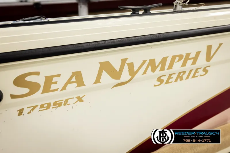 Slide: The Image of 1999 Lowe Sea Nymph V 179 SCX boat side view with branding and logo. - 51