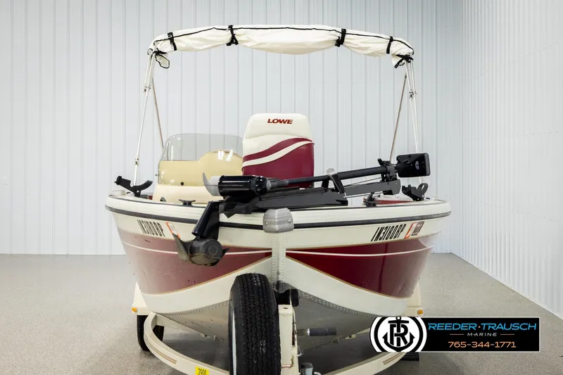 Slide: The Image of 1999 Lowe Sea Nymph V 179 SCX boat with canopy in showroom. - 7