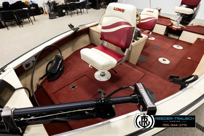 Slide: The Image of 1999 Lowe Sea Nymph V 179 SCX boat interior with red and white seating, trolling motor. - 9