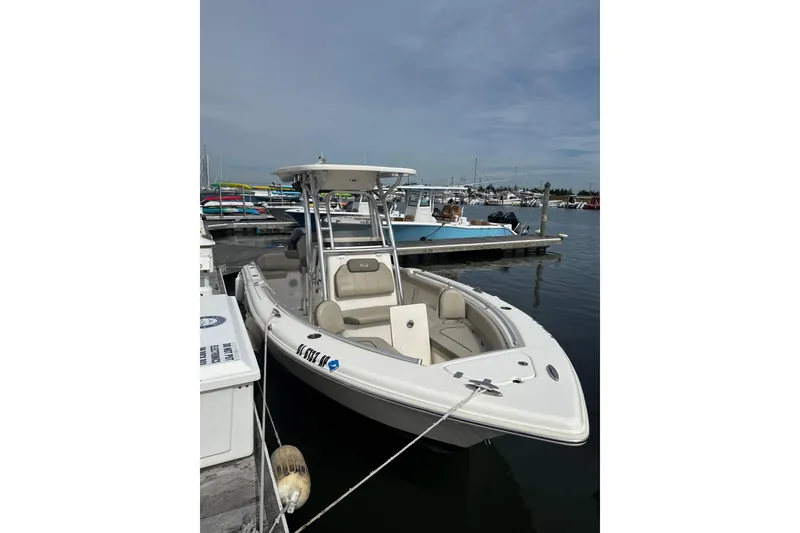The Image of 2024 Key West 239 FS boat docked at marina under clear sky. - 1