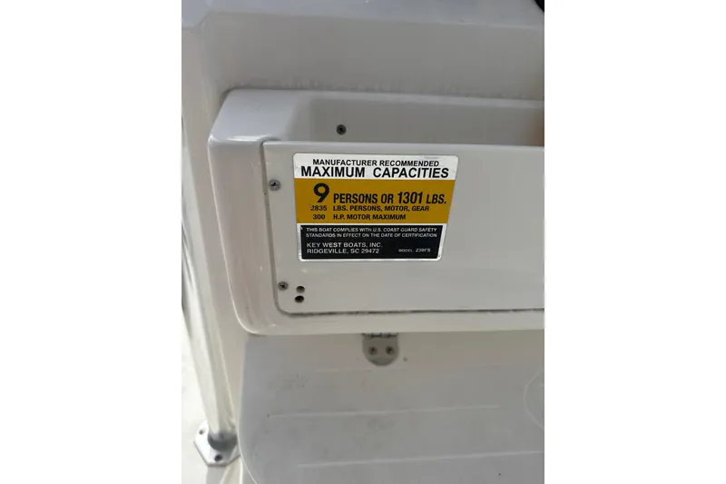 Slide: The Image of 2024 Key West 239 FS capacity label, 9 persons or 1301 lbs, 300 HP max. - 8