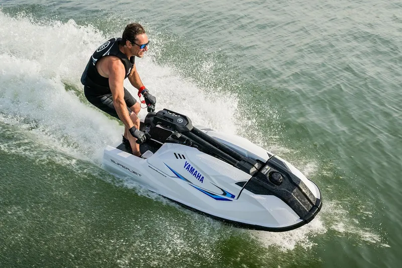 Slide: The Image of Manufacturer Provided Image: 2026 Yamaha WaveRunner SuperJet speeding on water with rider in action. - 2