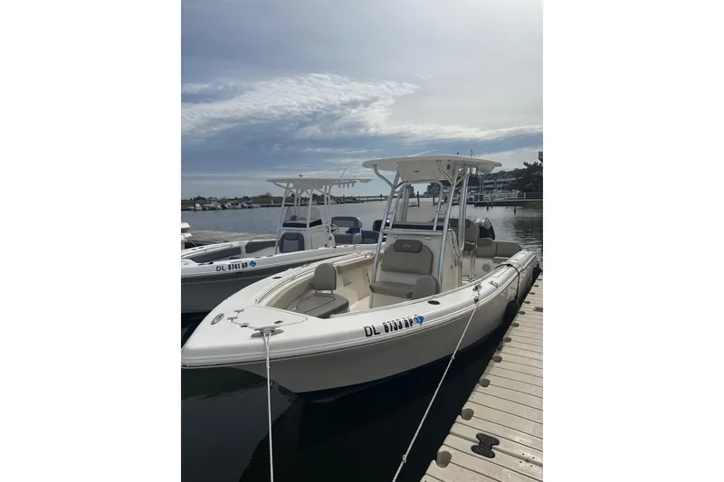 The Image of 2024 Key West 239 FS boat docked at marina under clear sky. - 1