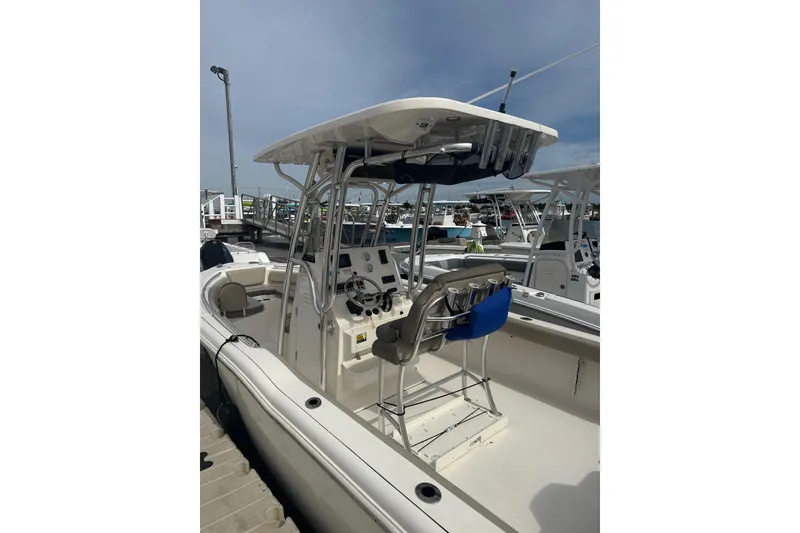 Slide: The Image of 2024 Key West 239 FS boat with center console and T-top in marina. - 3
