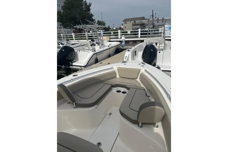 Slide: The Image of 2024 Key West 239 FS boat docked, featuring spacious seating and modern design. - 5