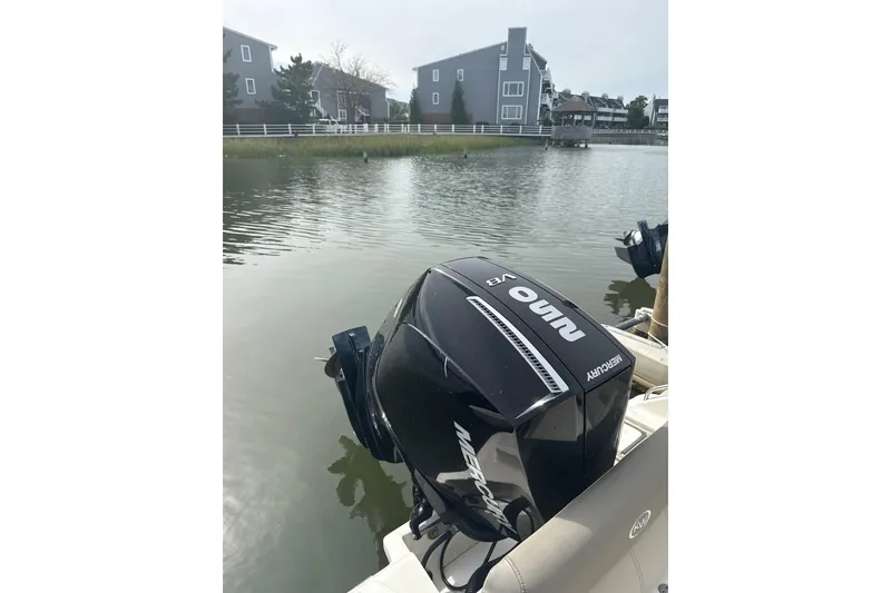 Slide: The Image of 2024 Key West 239 FS boat with Mercury outboard engine on a calm waterway. - 7