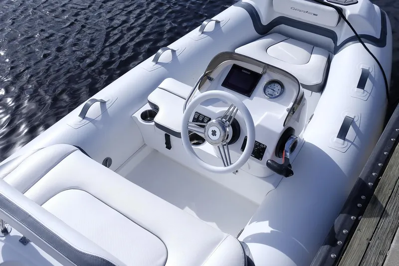 Slide: The Image of Manufacturer Provided Image: 2025 Walker Bay Generation 11 LTE boat interior with steering wheel and seating. - 8