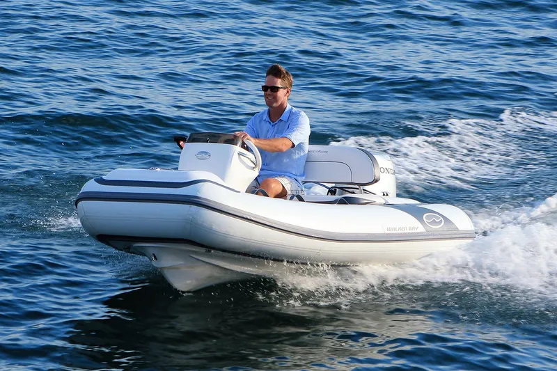 The Image of Manufacturer Provided Image: Man driving 2025 Walker Bay Generation 10 LTE boat on open water. - 0