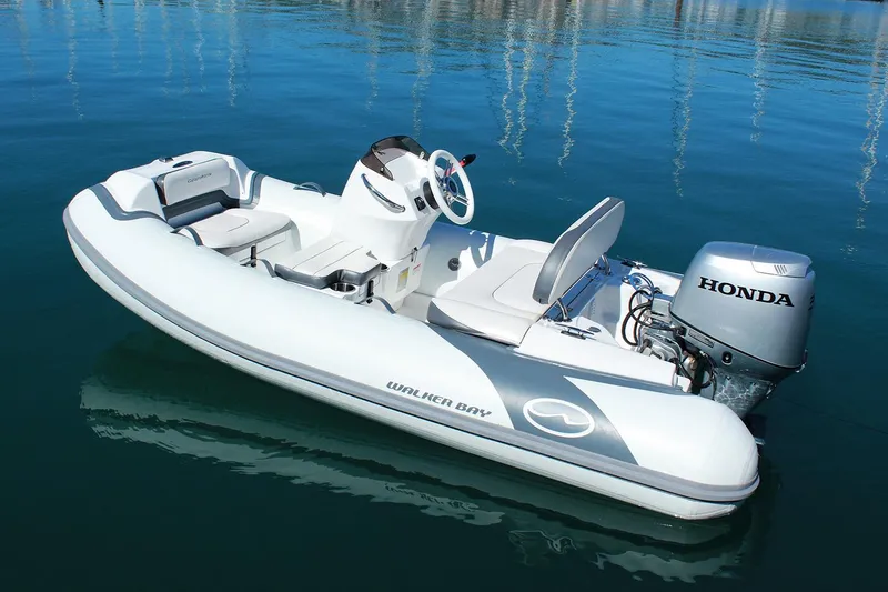 Slide: The Image of Manufacturer Provided Image: Walker Bay Generation 10 LTE 2025 inflatable boat with Honda motor on calm water. - 4