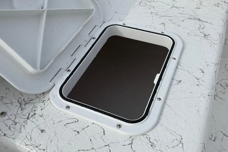 Slide: The Image of Open hatch on 2026 Coastal Skiff 271 boat with marbled deck design. - 10