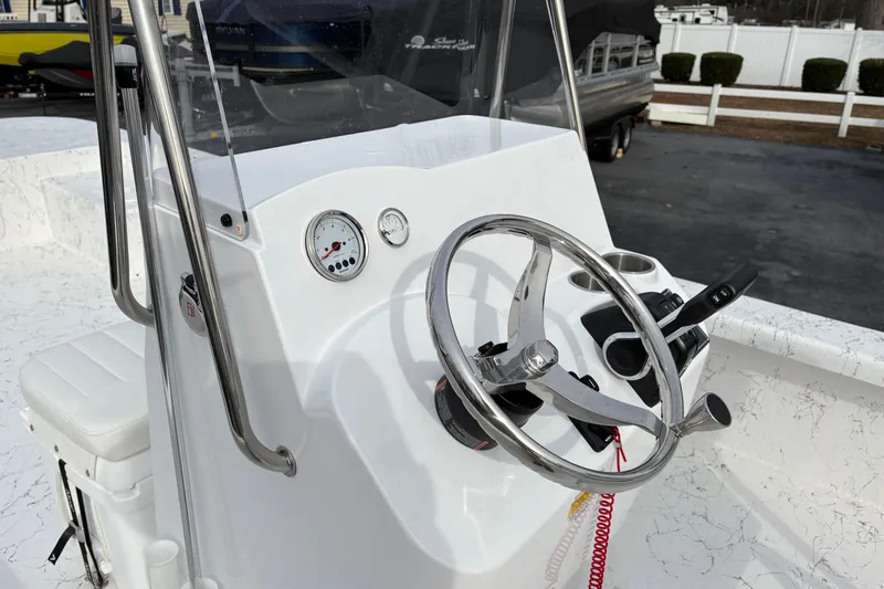 Slide: The Image of 2026 Coastal Skiff 271 boat console with steering wheel and gauges. - 13