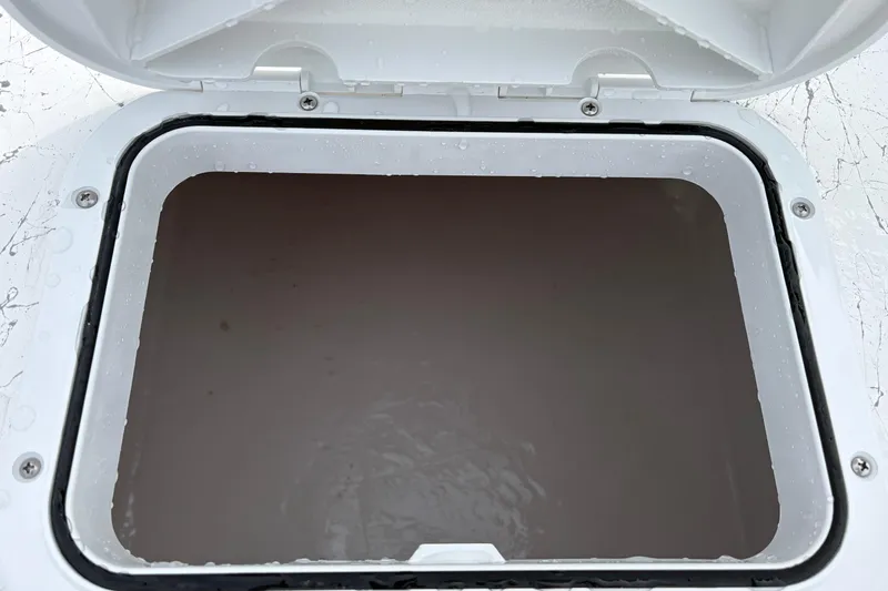 Slide: The Image of Open hatch on 2026 Coastal Skiff 271 boat, showing interior compartment. - 17