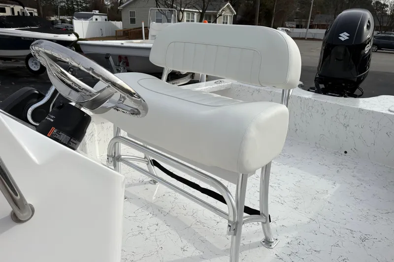 Slide: The Image of 2026 Coastal Skiff 271 boat interior with white seating and steering wheel. - 18