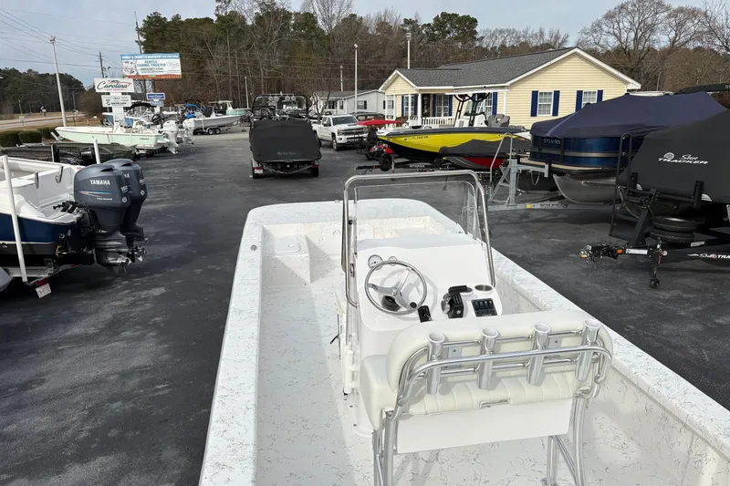 Slide: The Image of 2026 Coastal Skiff 271 boat displayed at a dealership with various other boats. - 4
