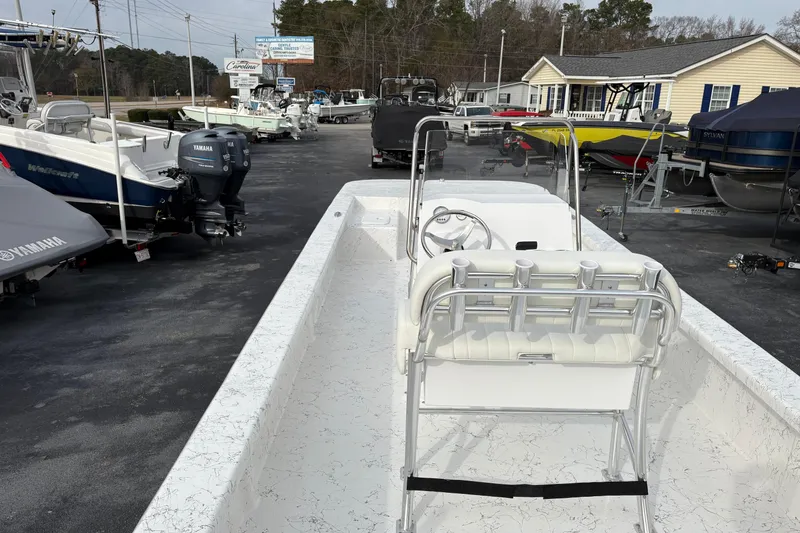 Slide: The Image of 2026 Coastal Skiff 271 boat displayed at a dealership with other boats. - 5