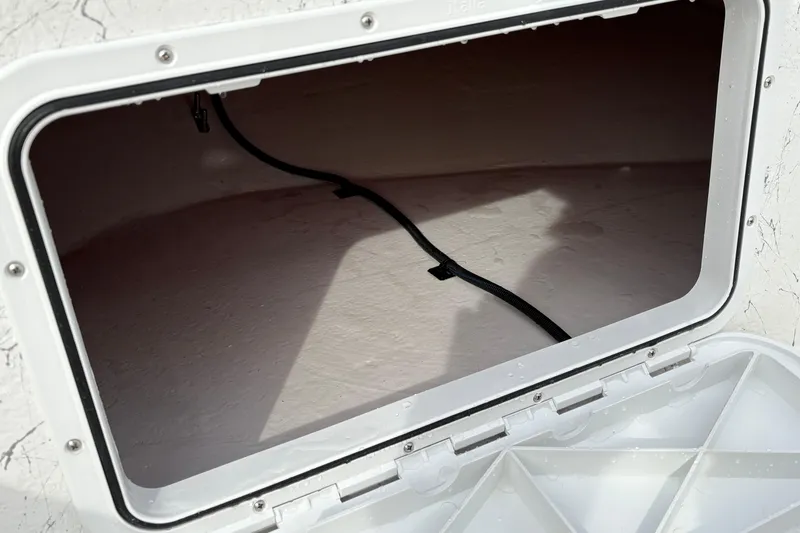 Slide: The Image of Open storage compartment of 2026 Coastal Skiff 271 boat, showing interior space. - 9