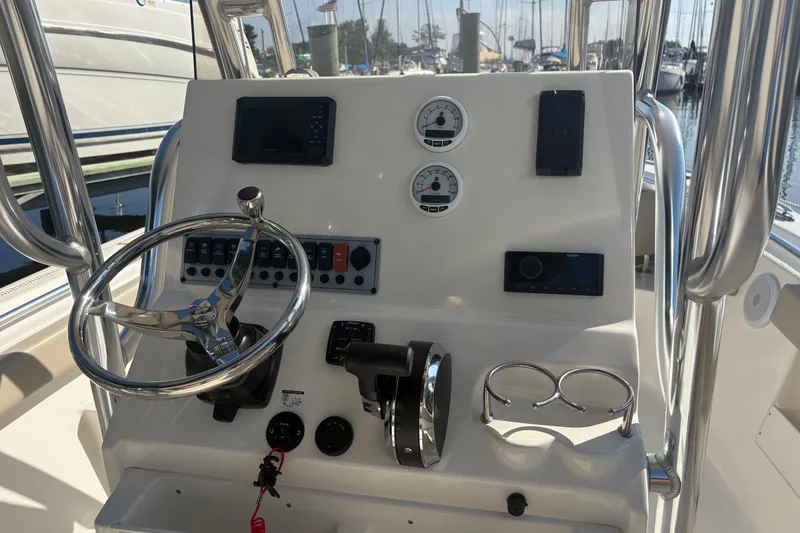 Slide: The Image of 2024 Key West 239 FS boat dashboard with steering wheel and control panel. - 3