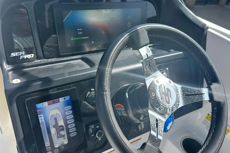 Slide: The Image of Steering console of 2022 Sea Pro Citation 2400 boat with digital displays. - 12