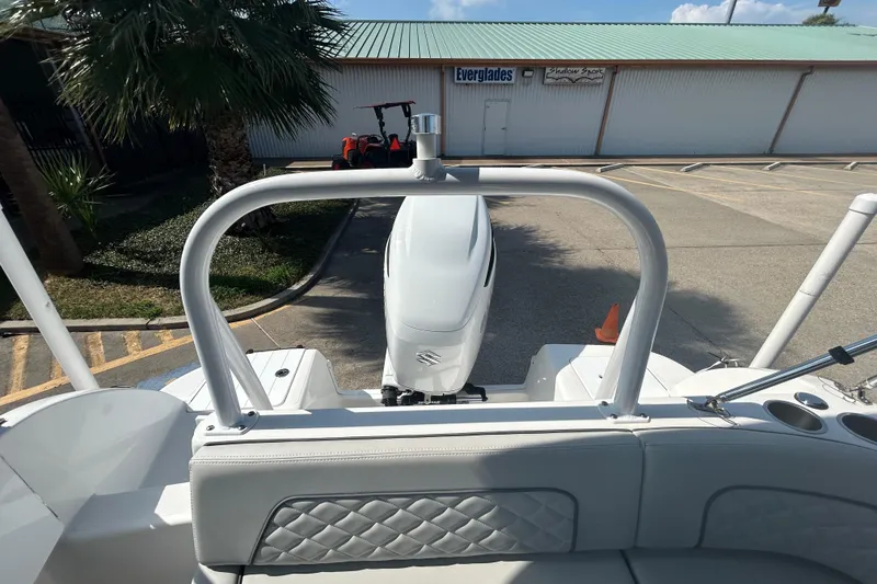 Slide: The Image of 2022 Sea Pro Citation 2400 boat with outboard motor, parked near a building. - 13