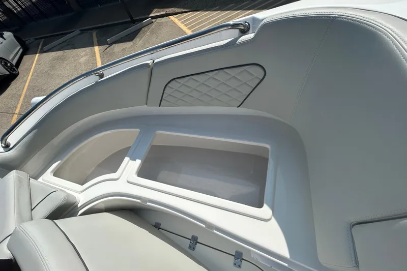 Slide: The Image of 2022 Sea Pro Citation 2400 boat interior with storage compartment and cushioned seating. - 14