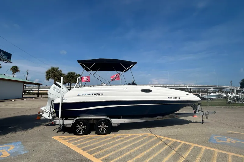 Slide: The Image of 2022 Sea Pro Citation 2400 boat on trailer, parked outdoors under clear blue sky. - 2