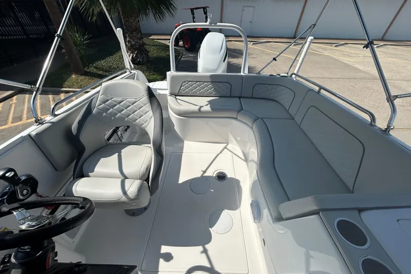 Slide: The Image of 2022 Sea Pro Citation 2400 boat interior with cushioned seating and steering wheel. - 20