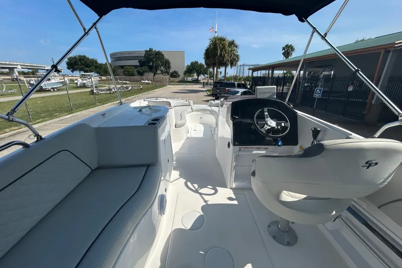 Slide: The Image of 2022 Sea Pro Citation 2400 boat interior with helm, seating, and canopy. - 21