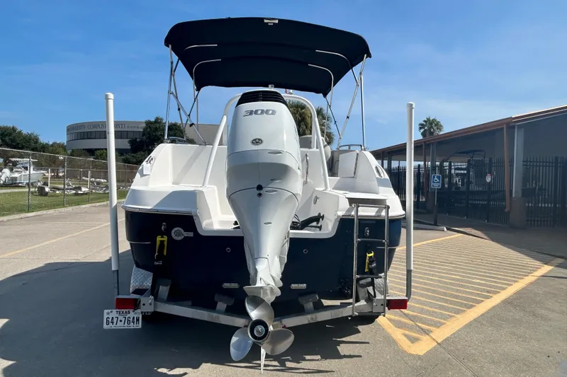 Slide: The Image of 2022 Sea Pro Citation 2400 boat with outboard motor on trailer in parking lot. - 4