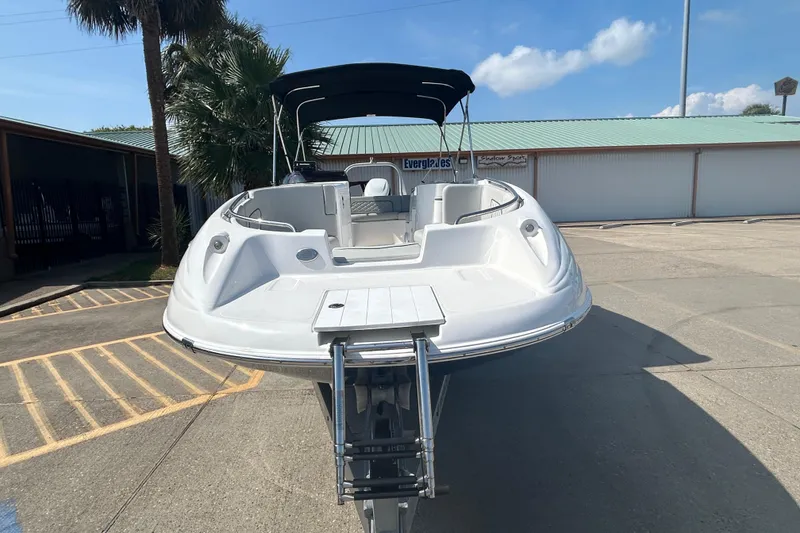 Slide: The Image of 2022 Sea Pro Citation 2400 boat with canopy, parked outdoors on a sunny day. - 6