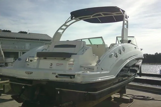 Slide: The Image of 2016 Chaparral 225 SSi boat docked, featuring sleek design and modern amenities. - 11