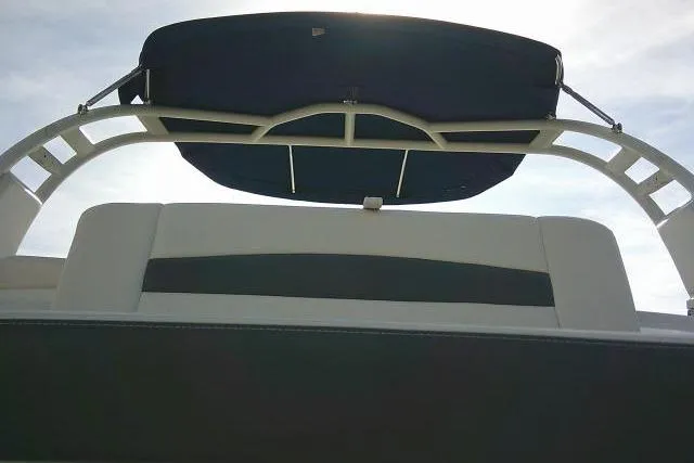 Slide: The Image of 2016 Chaparral 225 SSi boat with a sleek bimini top against the sky. - 14