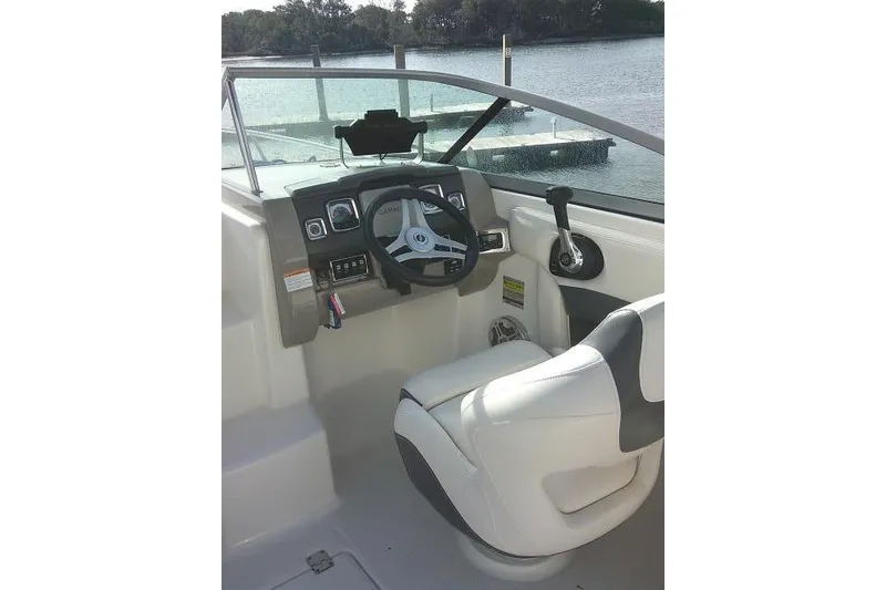 Slide: The Image of 2016 Chaparral 225 SSi boat cockpit with steering wheel and controls. - 17