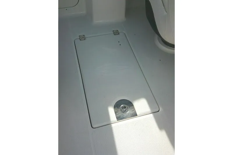 Slide: The Image of 2016 Chaparral 225 SSi boat floor compartment with metal latch and hinges. - 18