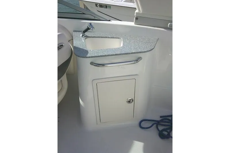 Slide: The Image of 2016 Chaparral 225 SSi boat interior with sink and storage cabinet. - 19