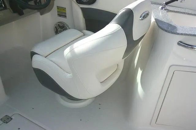Slide: The Image of 2016 Chaparral 225 SSi boat interior with white and gray captain's chair. - 27