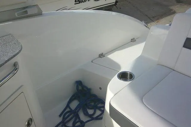 Slide: The Image of 2016 Chaparral 225 SSi boat interior with seating, cup holder, and blue rope. - 29