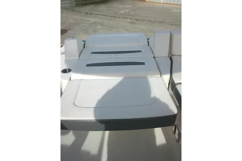 Slide: The Image of 2016 Chaparral 225 SSi boat interior with white cushioned seating. - 33