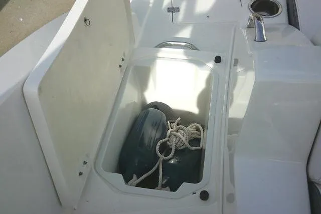 Slide: The Image of 2016 Chaparral 225 SSi boat storage compartment with rope and fender. - 34