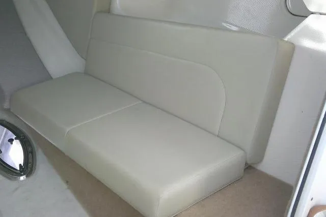 Slide: The Image of 2016 Chaparral 225 SSi boat interior with beige seating and carpeted flooring. - 39