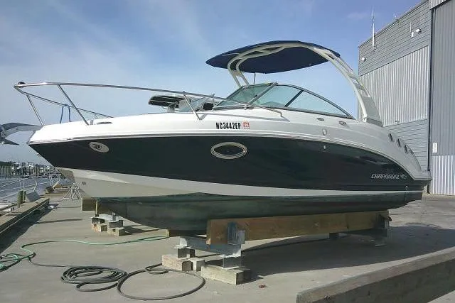 Slide: The Image of 2016 Chaparral 225 SSi boat on dock, featuring sleek design and modern amenities. - 4