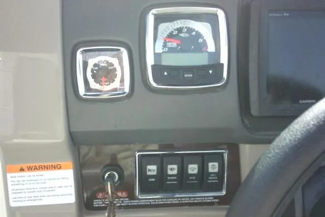 Slide: The Image of Dashboard of 2016 Chaparral 225 SSi boat with gauges and control switches. - 43