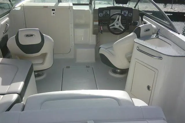 Slide: The Image of 2016 Chaparral 225 SSi boat interior with seating, steering wheel, and sink. - 50