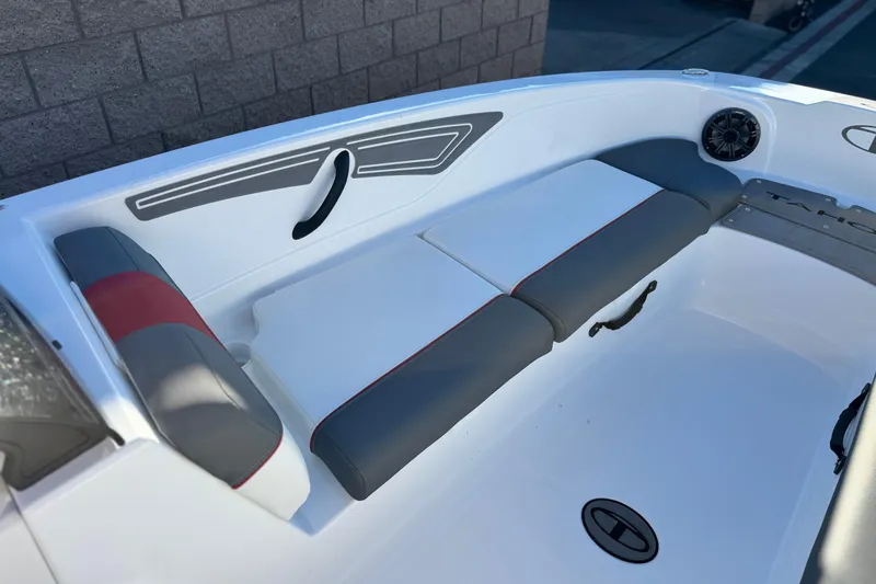 Slide: The Image of 2024 Tahoe T21 boat interior with gray and red cushioned seating. - 10