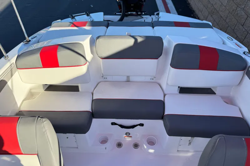 Slide: The Image of 2024 Tahoe T21 boat interior with gray and red cushioned seating. - 13