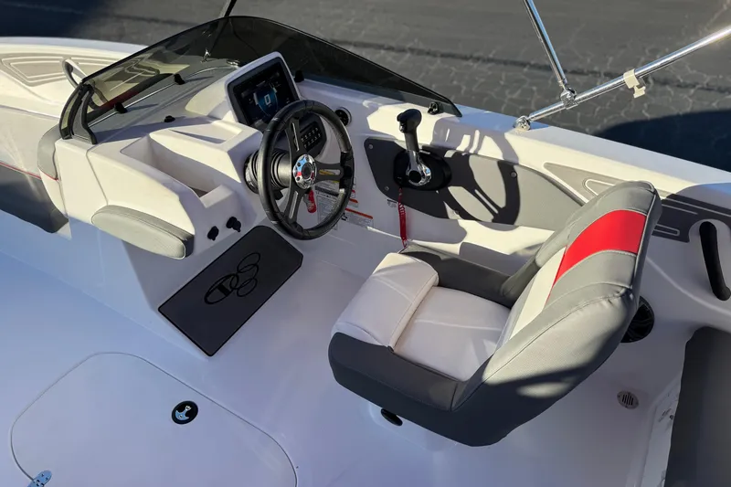 Slide: The Image of 2024 Tahoe T21 boat interior with steering wheel and seating. - 19
