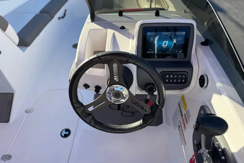 Slide: The Image of 2024 Tahoe T21 boat dashboard with steering wheel and digital display. - 20